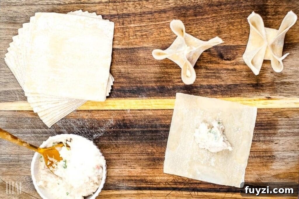 Crispy Air Fryer Crab Rangoon Recipe 5 top shot of placing crab in wonton wrappers