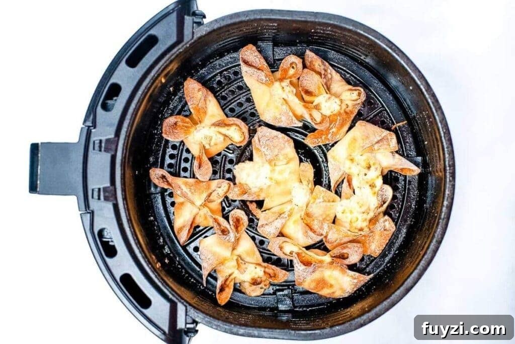Crispy Air Fryer Crab Rangoon Recipe 6 top shot of crab rangoons in the air fryer basket after cooking