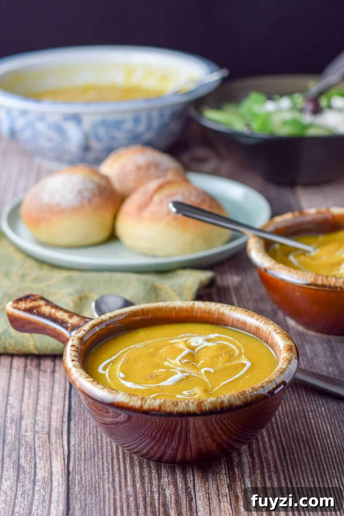 Creamy Roasted Butternut Squash Soup Recipe 2 two bowls of squash soup with rolls in the background