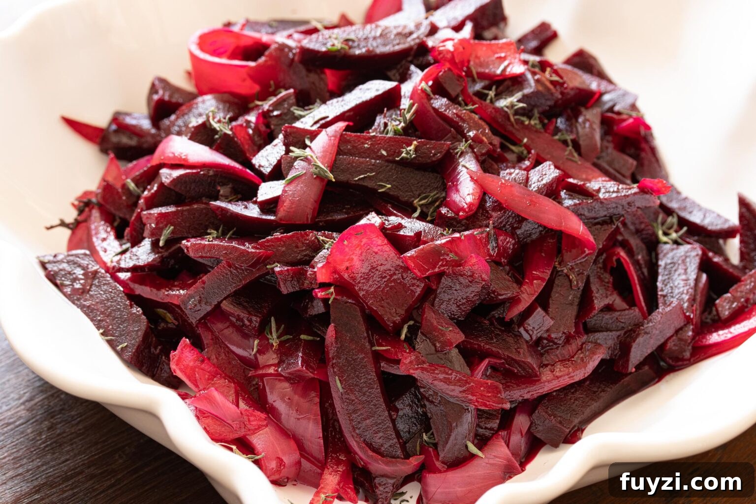 roasted beet and onion salad on a white serving dish