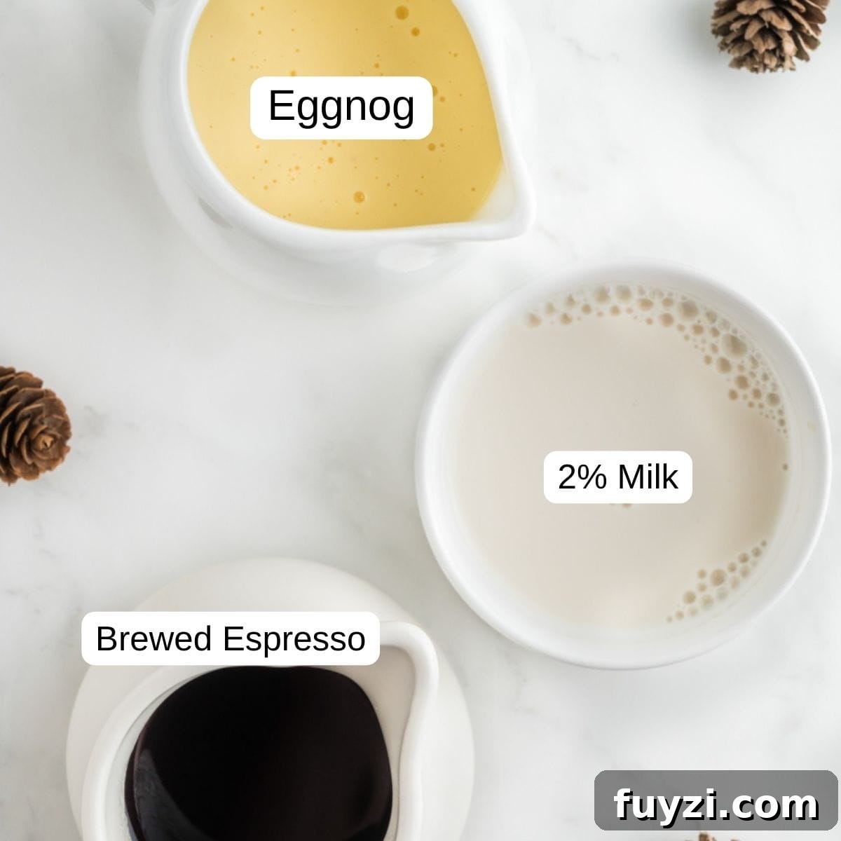 A measuring cup with eggnog and milk ready to be frothed.