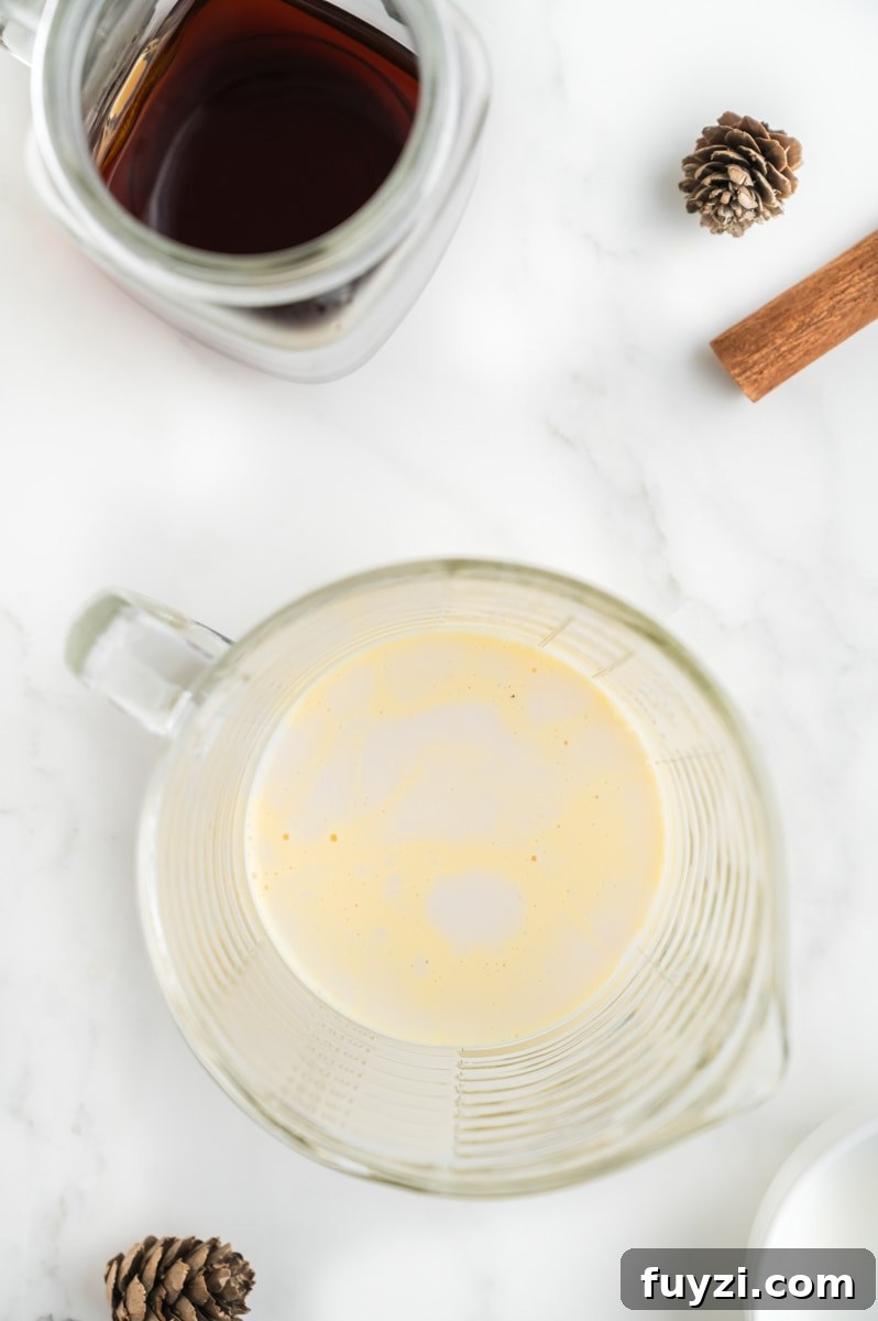 Warmed eggnog and milk in a measuring cup.