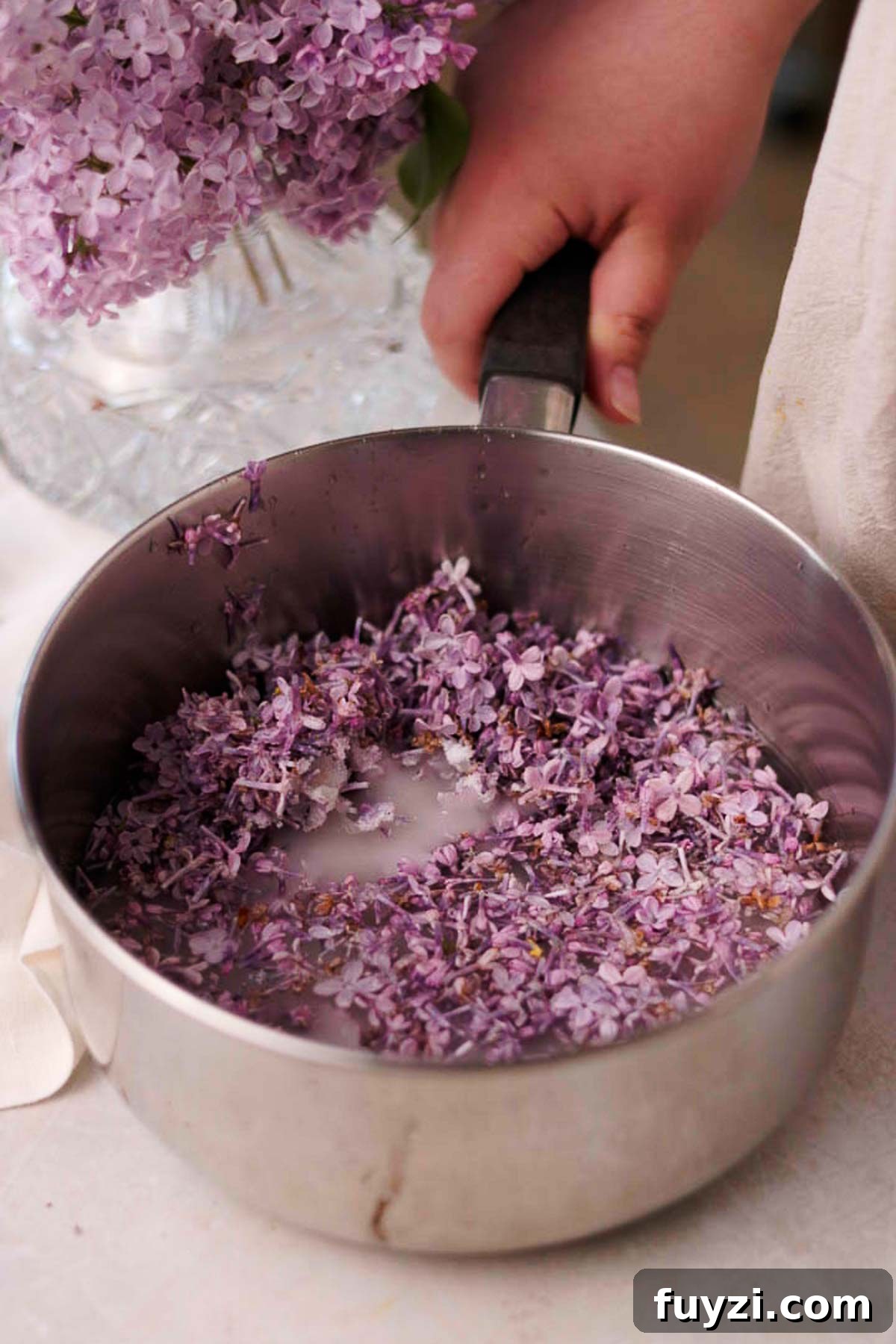 Lilac Lemonade Recipe: How to Make a Floral Citrus Drink 6 uncooked lilac syrup in a metal saucepan