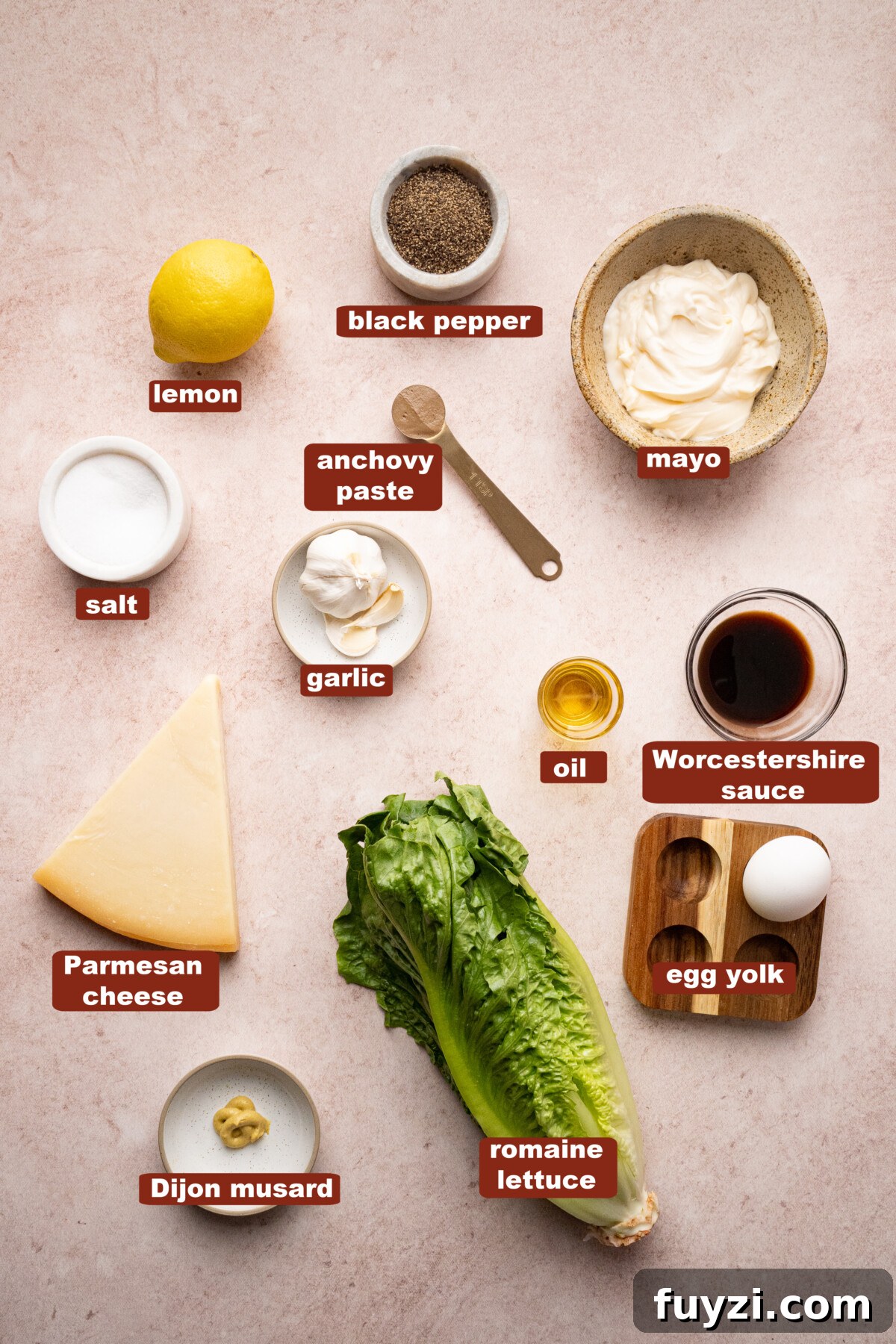 Classic Caesar Salad Recipe with Homemade Dressing 2 All of the ingredients for caesar salad in bowls on a countertop.