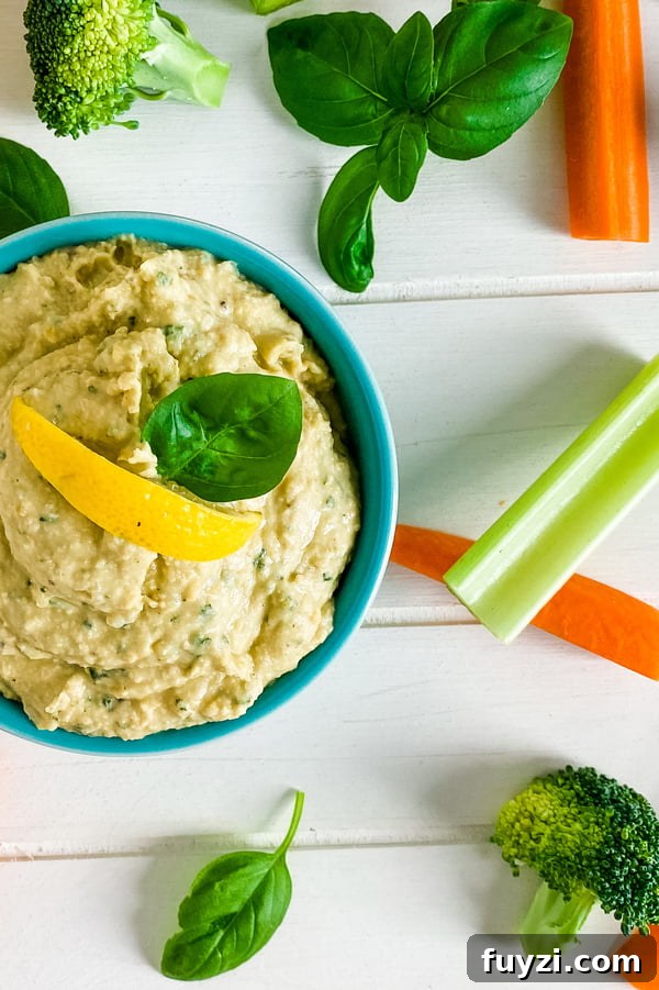 Garden Fresh Basil Hummus Recipe 4 bowl of basil hummus with celery and carrot sticks