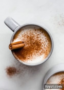 a blue cup filled with a pumpkin latte in it topped with cinnamon