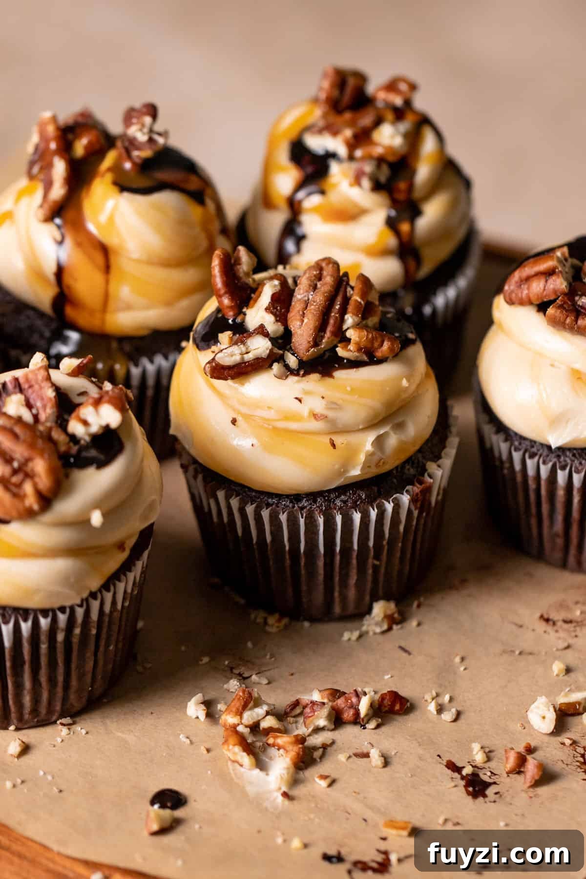 Chocolate Turtle Cupcakes Recipe with Caramel and Pecans 2 Chocolate turtle cupcakes with caramel swirled buttercream, chocolate ganache, and pecans.