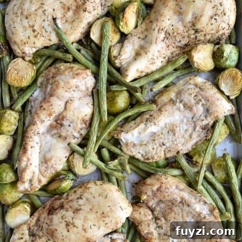 sheet pan with baked chicken, green beans, and brussel sprouts
