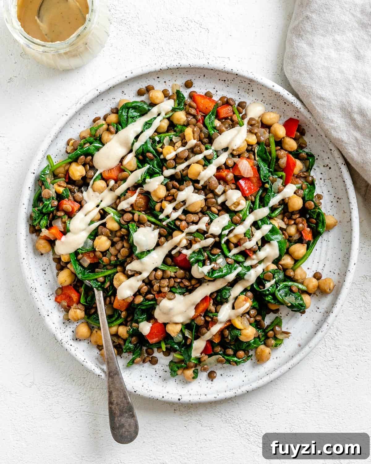 Zesty Vegan Lentil and Chickpea Salad 2 completed Vegan Lentil Chickpea Salad plated on a white plate against a white surface
