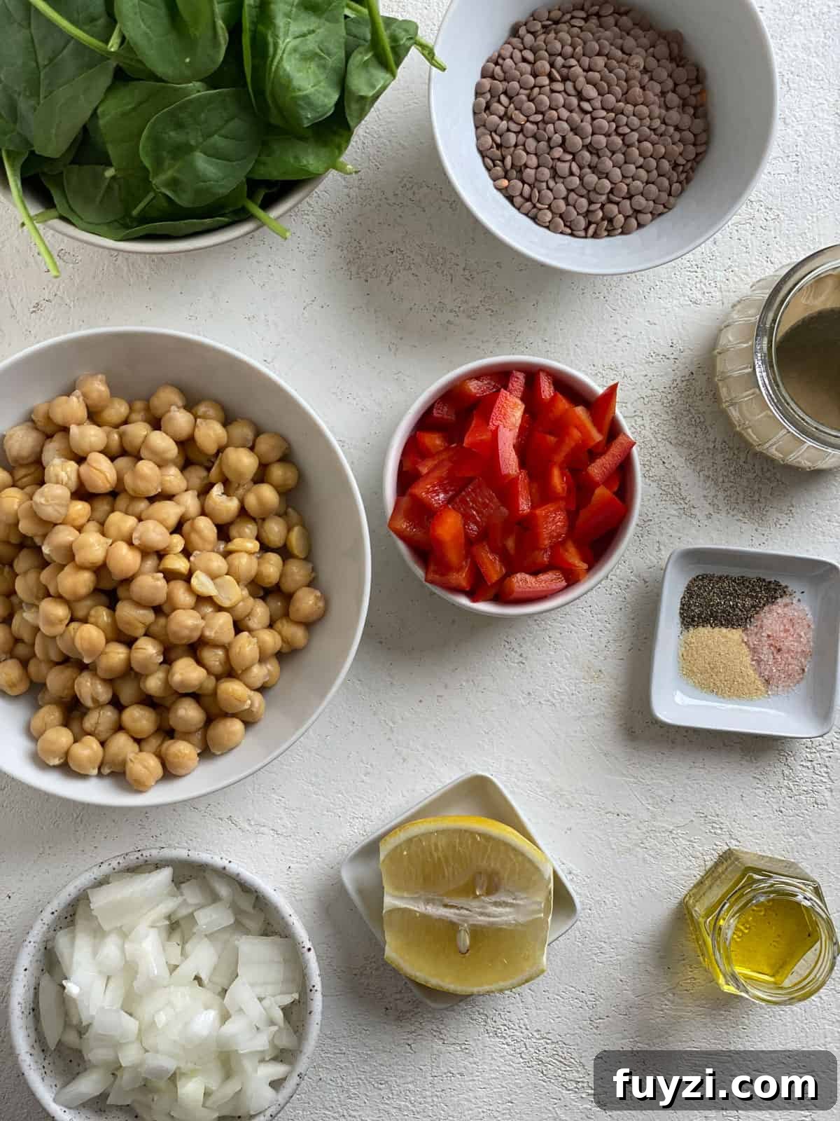 Zesty Vegan Lentil and Chickpea Salad 3 ingredients for Vegan Lentil Chickpea Salad measured out against a white surface