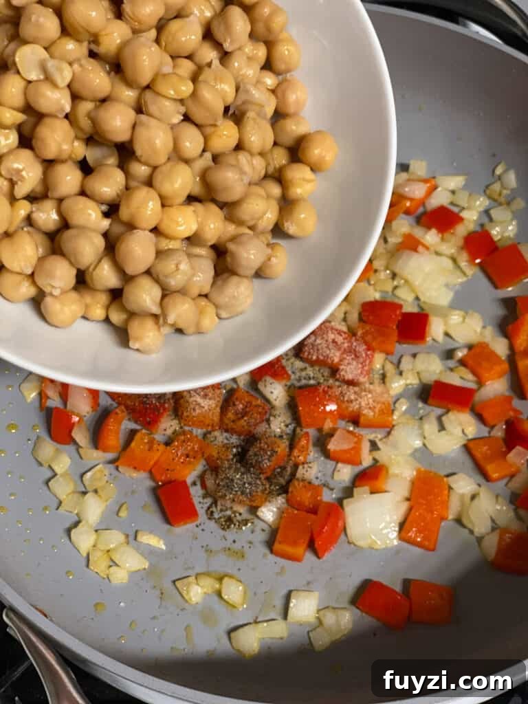 Zesty Vegan Lentil and Chickpea Salad 8 process shot of adding chickpeas to a pan