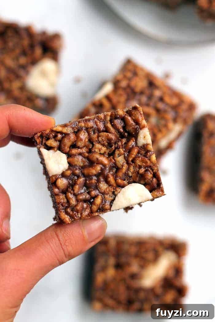 Stacked peppermint chocolate rice krispie treats with marshmallows pressed on top