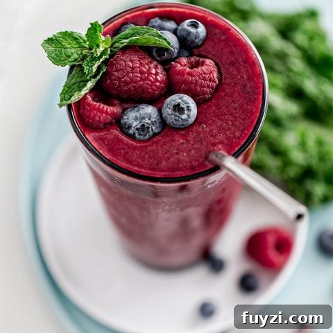 15 Nutritious Snacks to Kickstart Your New Year 13 Glass with berry mango kale smoothie and straw