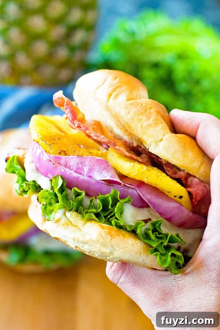Grilled Pineapple Teriyaki Chicken Burger in hand