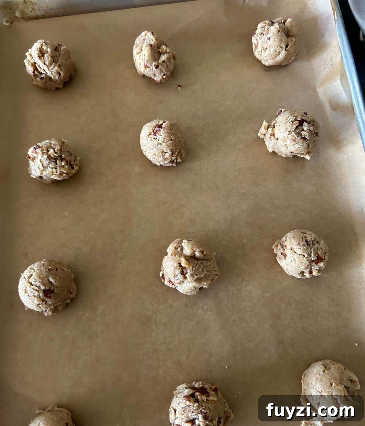 Cookie balls on cookie sheet.
