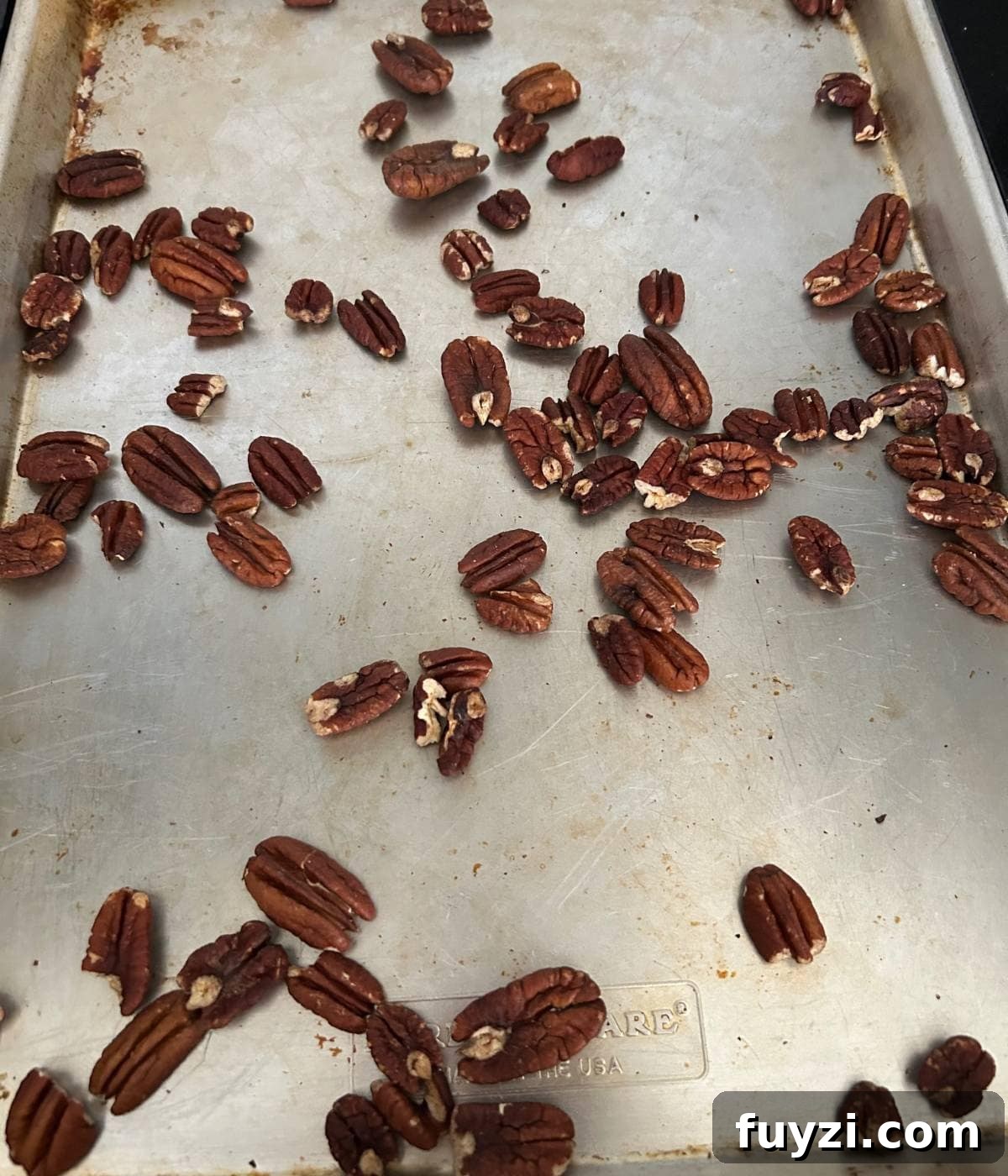 Pecans on cookie sheet.