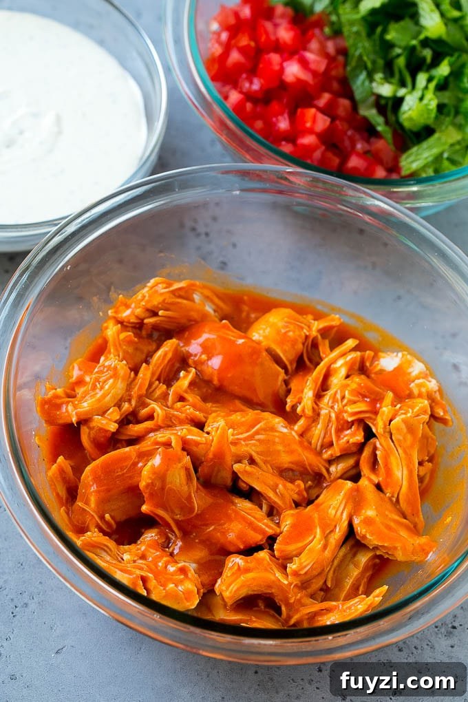 Buffalo Chicken Tacos with Creamy Blue Cheese Slaw 6 Chicken tossed with buffalo sauce along with bowls of ranch, tomatoes and lettuce.