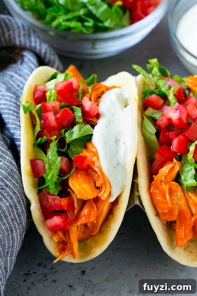 Buffalo Chicken Tacos with Creamy Blue Cheese Slaw 8 Buffalo chicken tacos filled with shredded chicken, lettuce, tomato and ranch sauce.