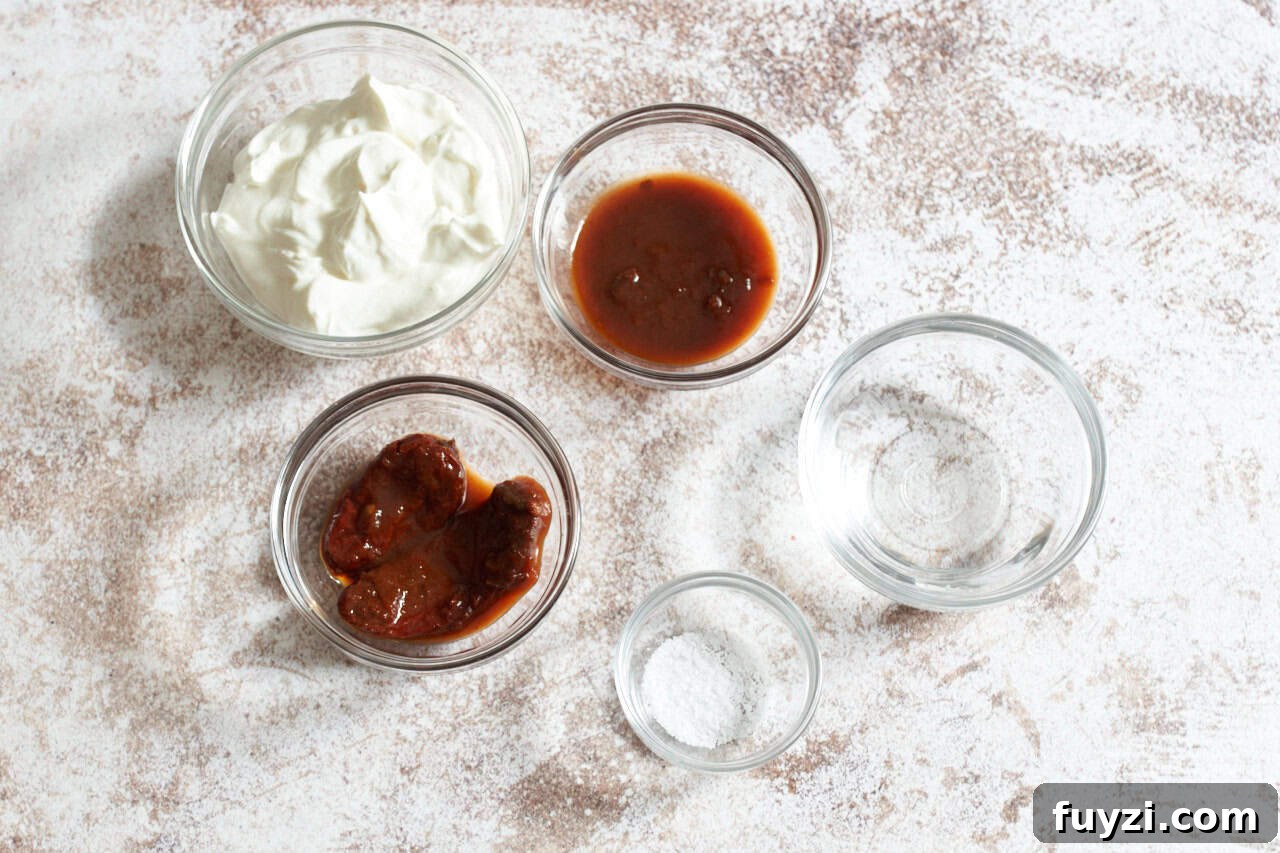 Small glass bowls of sour cream, chipotle chilis, adobo sauce, water, and salt.