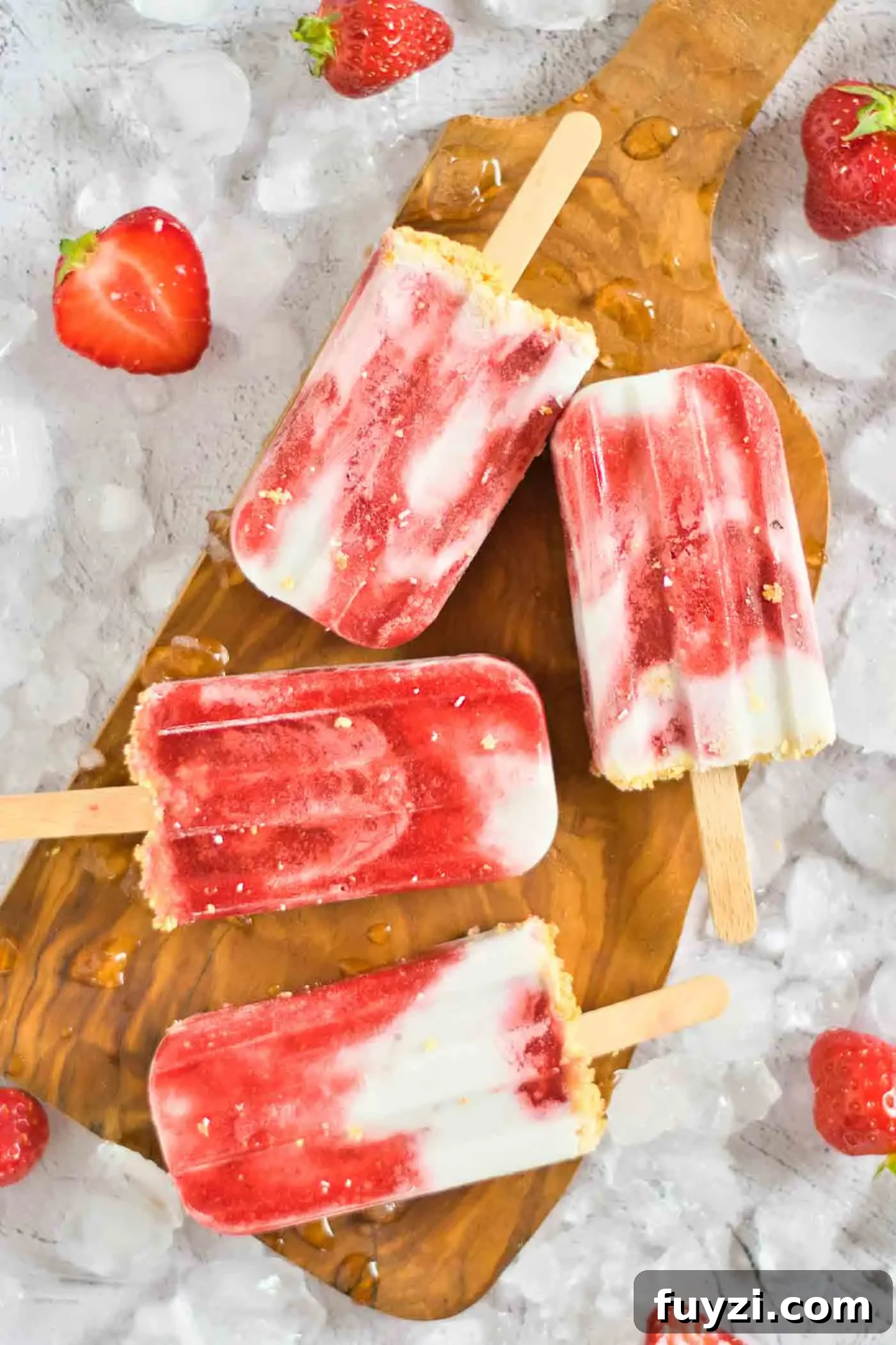 Homemade Strawberry Popsicles Recipe 7 close up of cream popsicles on ice cubes