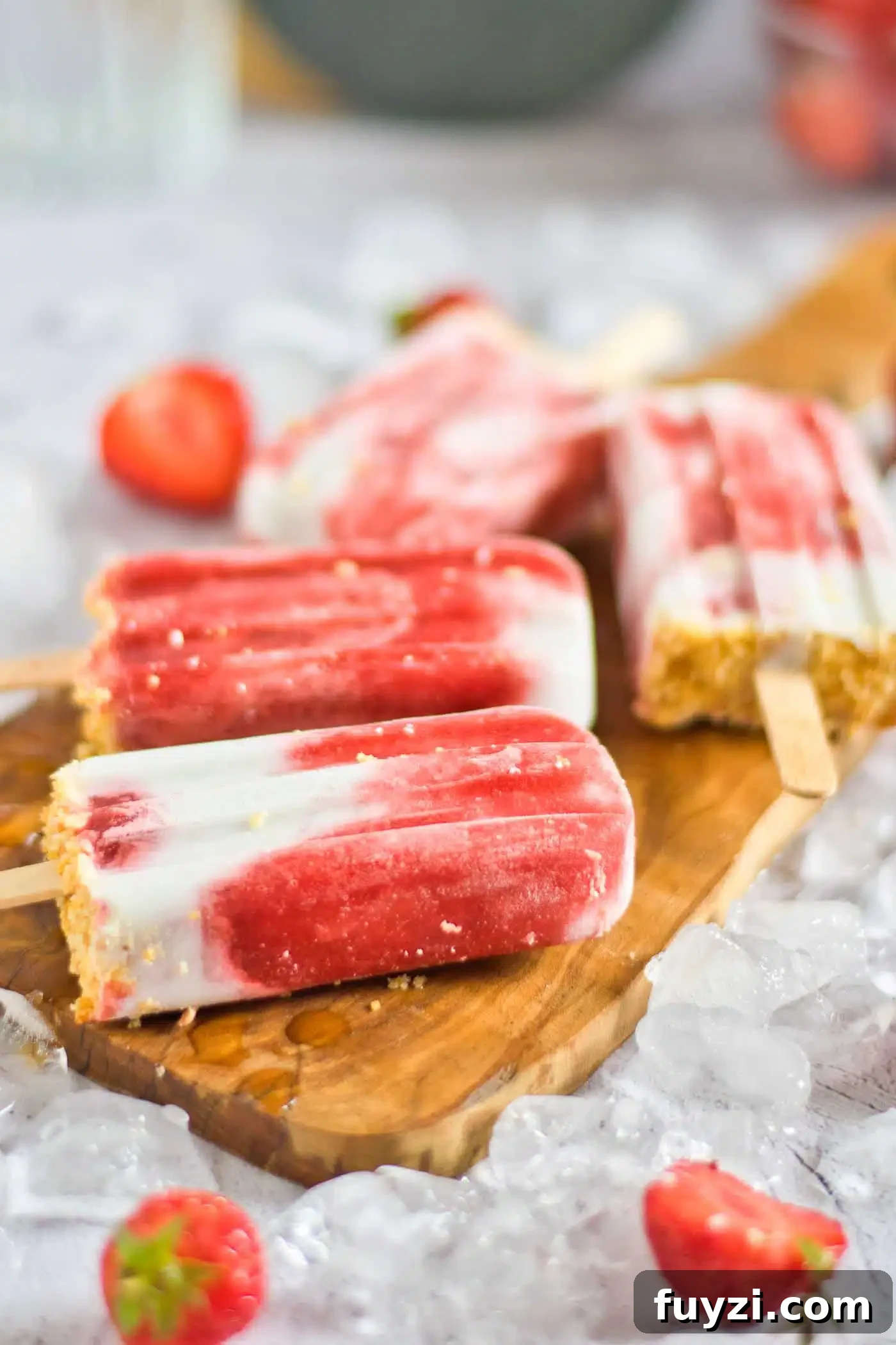 Homemade Strawberry Popsicles Recipe 8 popsicles on a board
