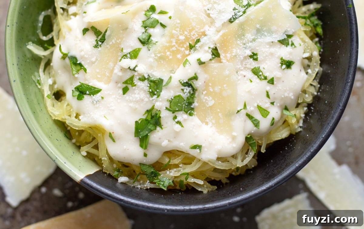 Creamy Garlic Parmesan Sauce Recipe 3 Garlic Parmesan Cream Sauce on spaghetti squash in bowl.