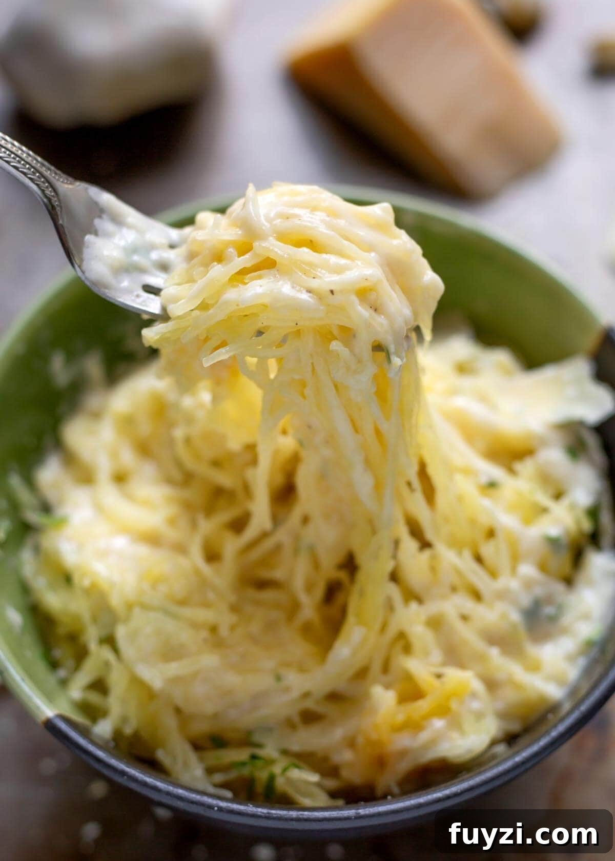 Creamy Garlic Parmesan Sauce Recipe 4 Garlic Parmesan Sauce on spaghetti squash on a fork.