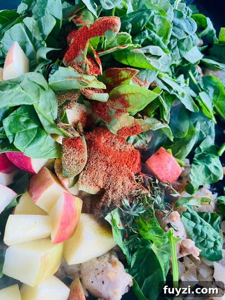 adding the diced apples and spinach to the griddle