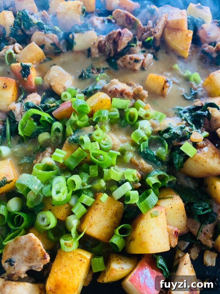 adding the sauce, green onions and dried cranberries
