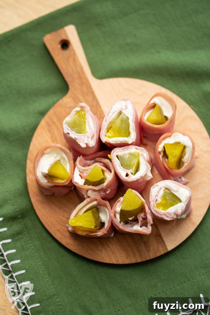 Small cutting board filled with sliced pickle treat appetizers.