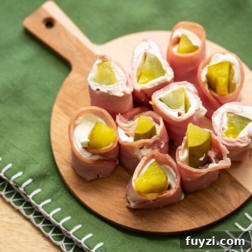 Overhead view of a round board full of pickle treat appetizers.