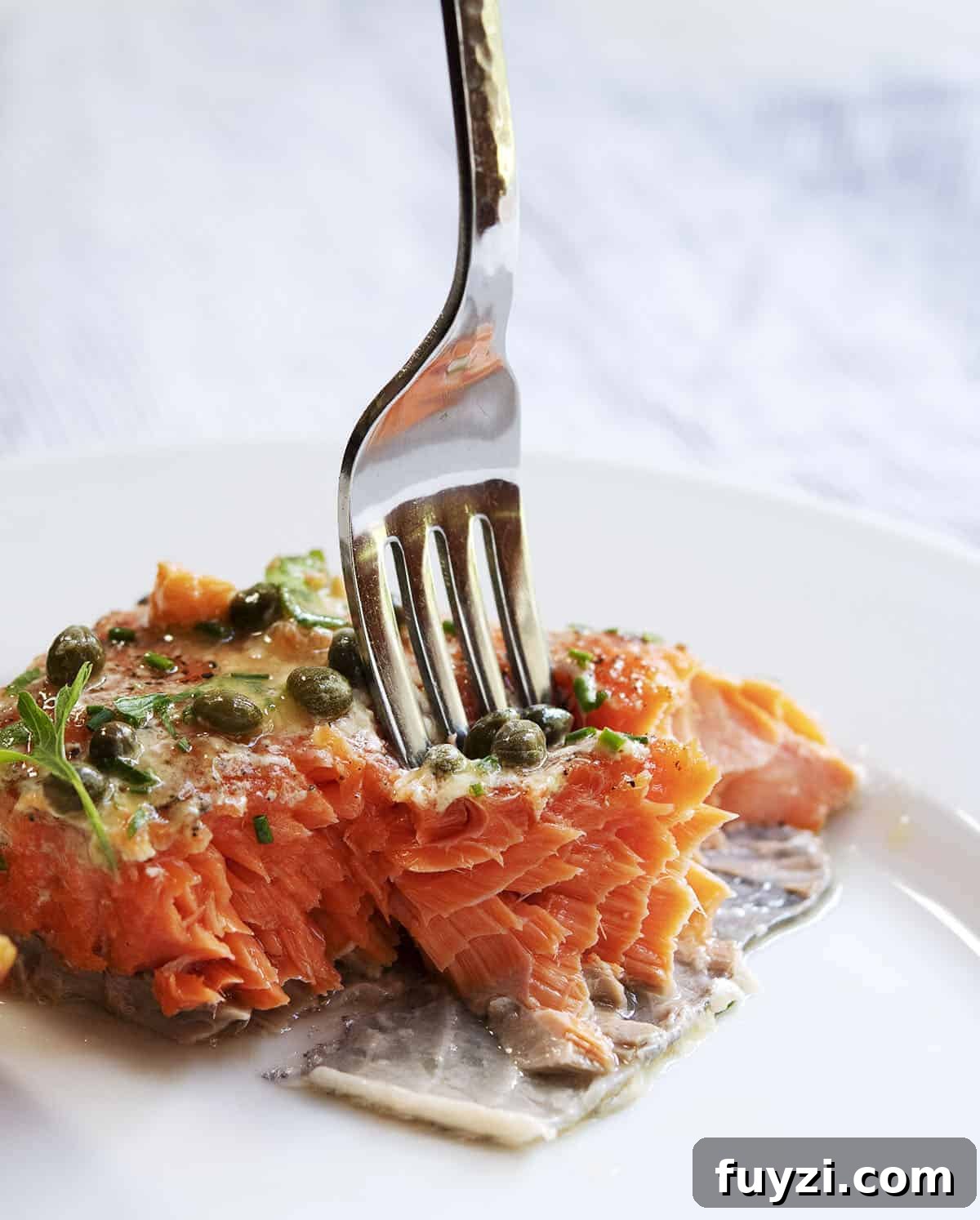Taking a bite of slow roasted salmon