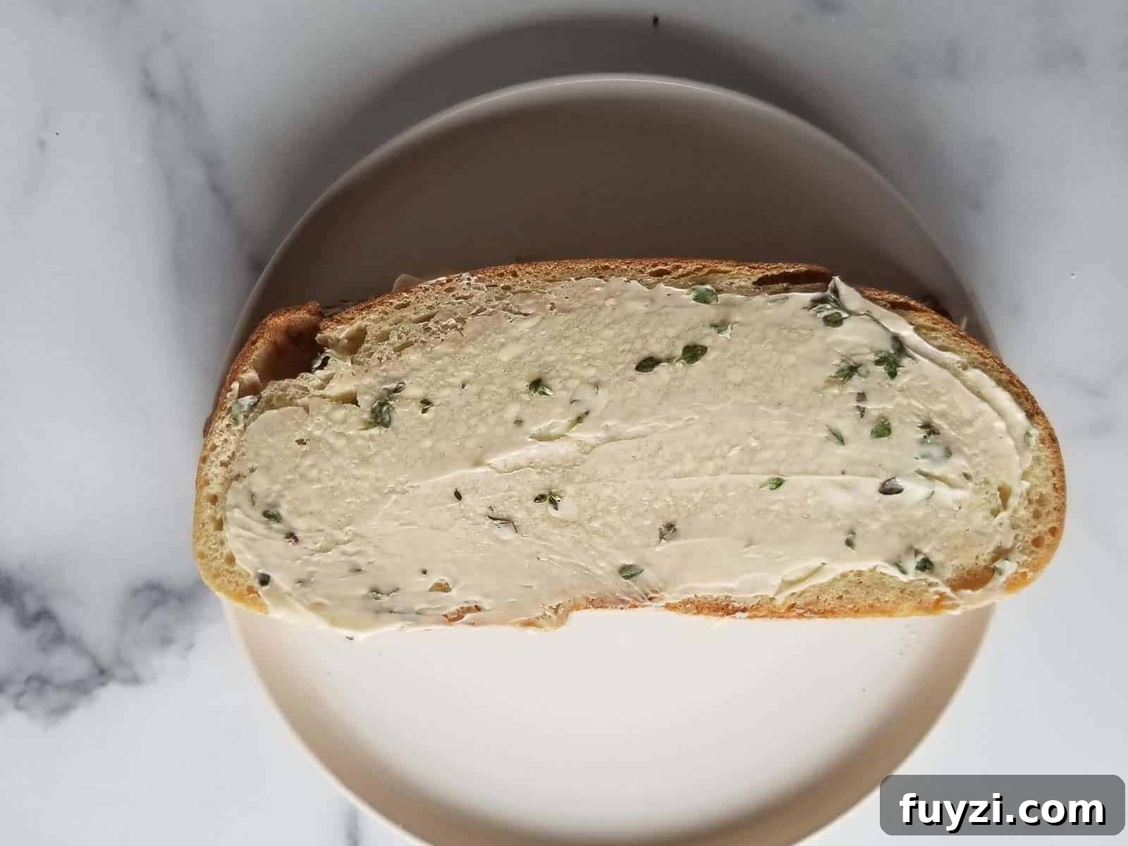 Gorgonzola and Pear Grilled Cheese Recipe with Jam 7 Bread spread with thyme butter ready to be grilled.