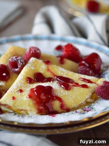Gorgonzola and Pear Grilled Cheese Recipe with Jam 9 Close-up of ricotta and lemon stuffed crepes with a raspberry sauce on top.