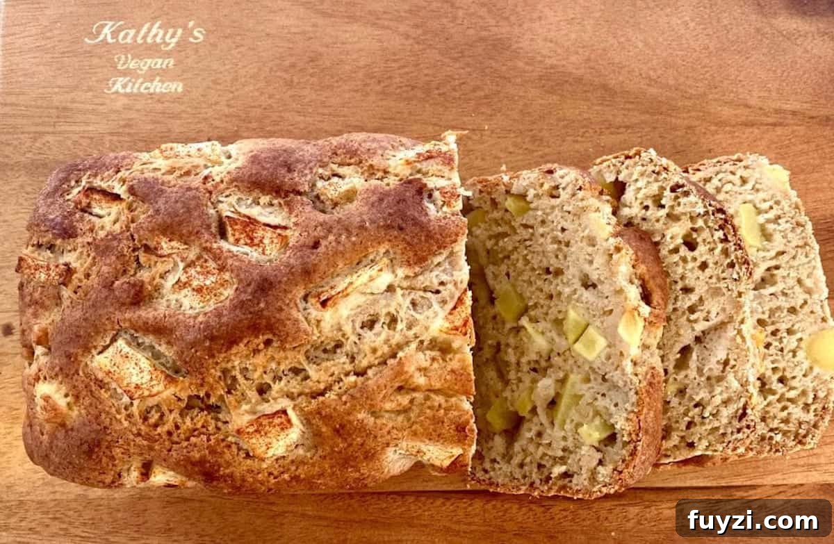apple cinnamon bread cut into slices on a cutting board 