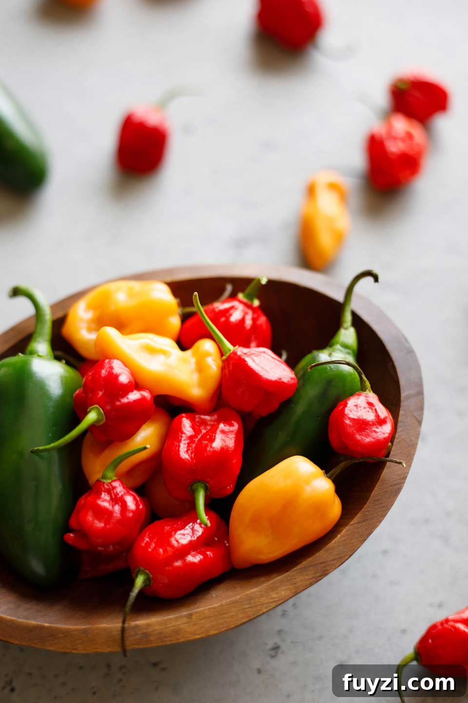 Wooden bowl of jalapeno and other hot peppers.