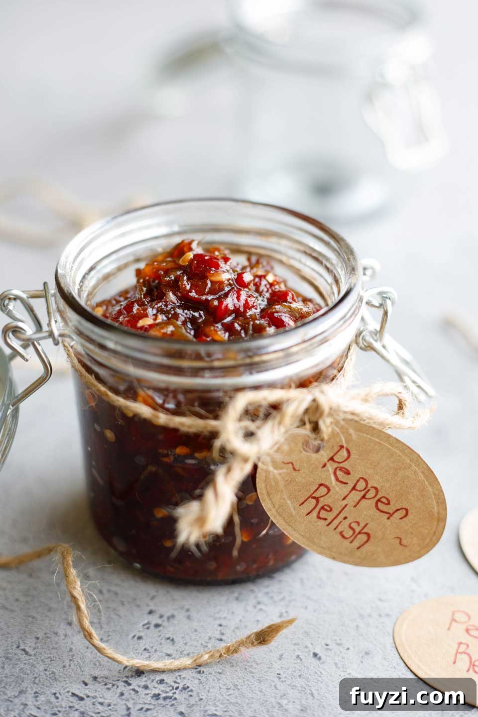 Recipe presented in a canning jar with brown string tied around and a gift tag reading "Pepper Relish".