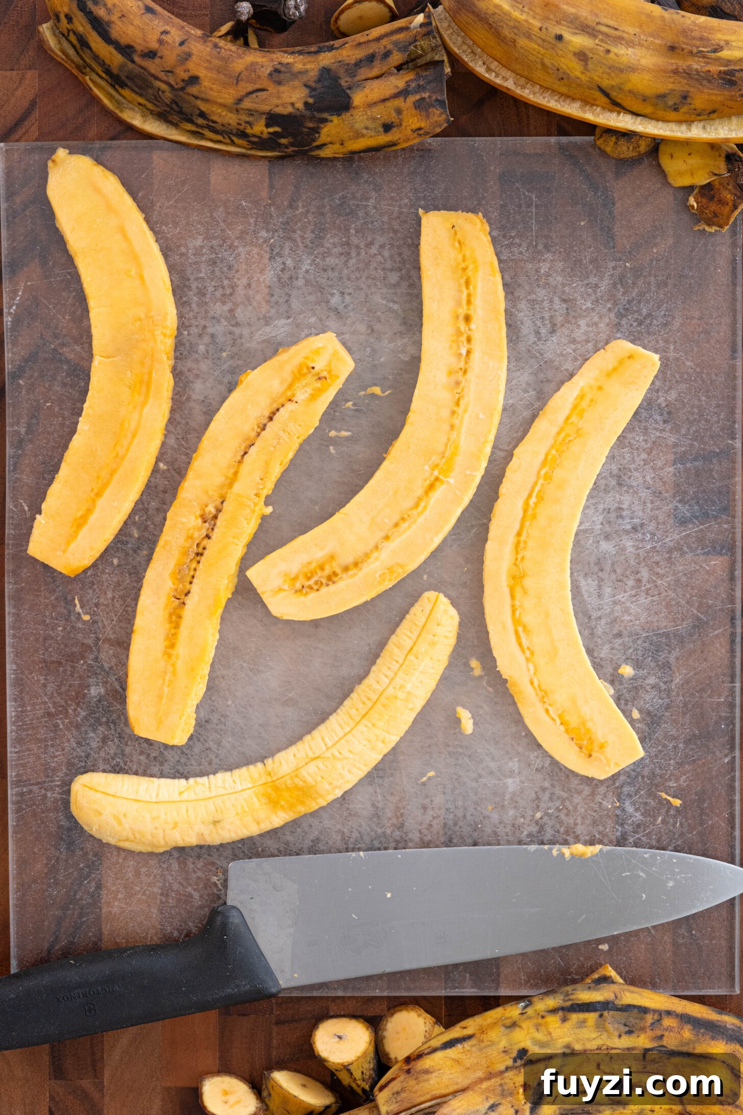 Sliced brown plantains on a cutting board.