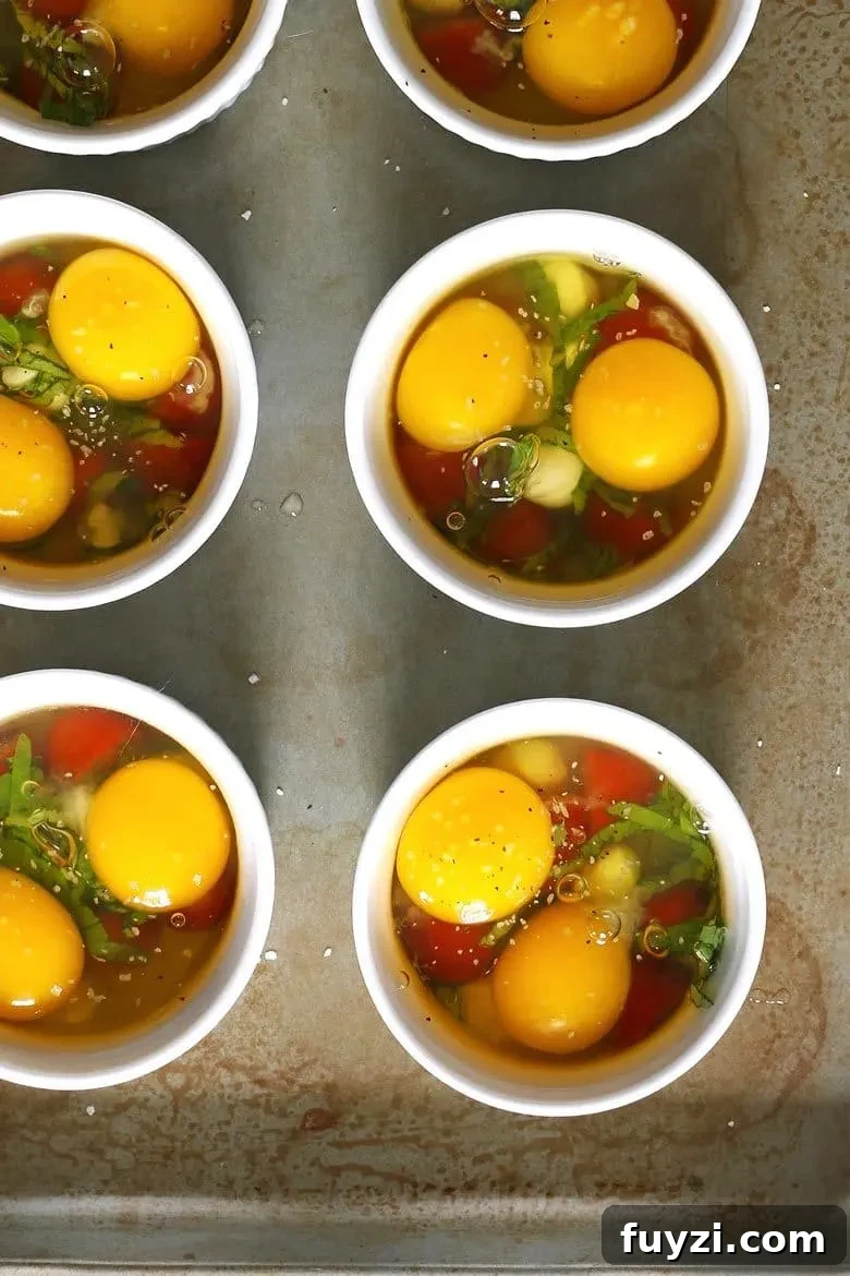 Assembling Caprese baked eggs in ramekins