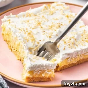 square slice of pineapple lush with piece on fork