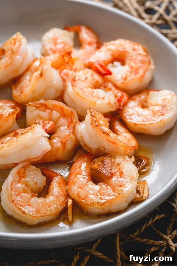 Plump, succulent shrimp sautéed in an aromatic garlic butter - a perfect dinner in minutes. Watch for these visual cues for perfectly cooked soft shrimp!