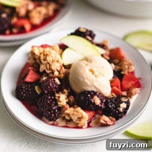 Close up view of a fruit crumble on a plate.