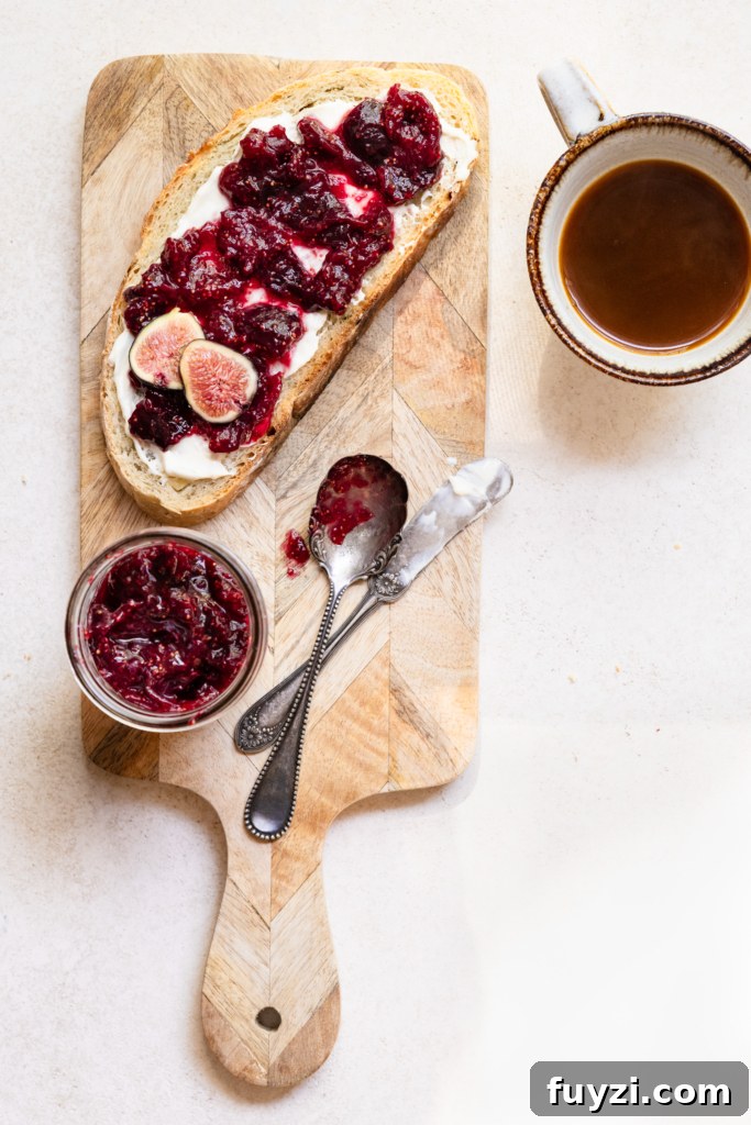 Homemade Fig Jam: Small-Batch Recipe 8 Slice of bread covered in fig jam on a cutting board next to a jar of fig jam and a cup of coffee.
