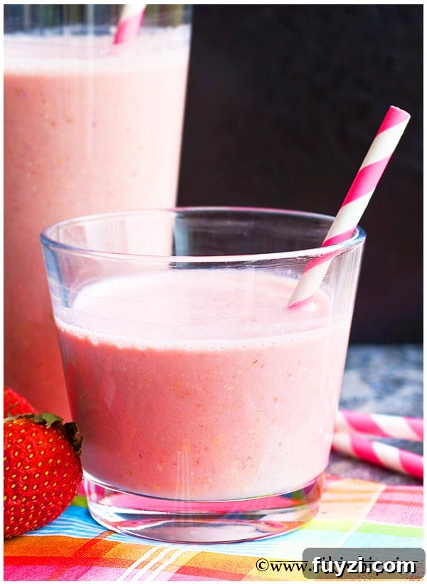 Easy Homemade Strawberry Smoothie in a Clear Glass with Straw