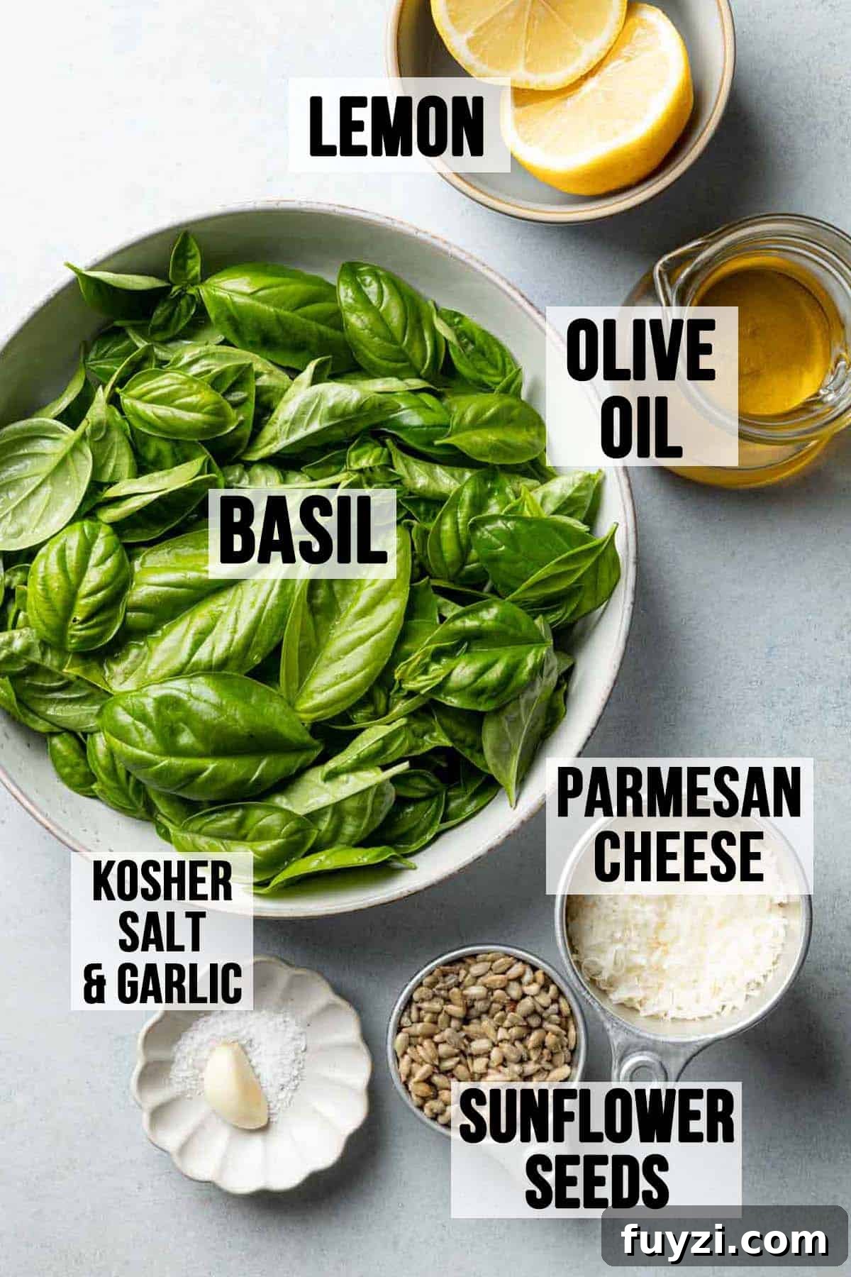 Ingredients for pesto without pine nuts laid out on surface.