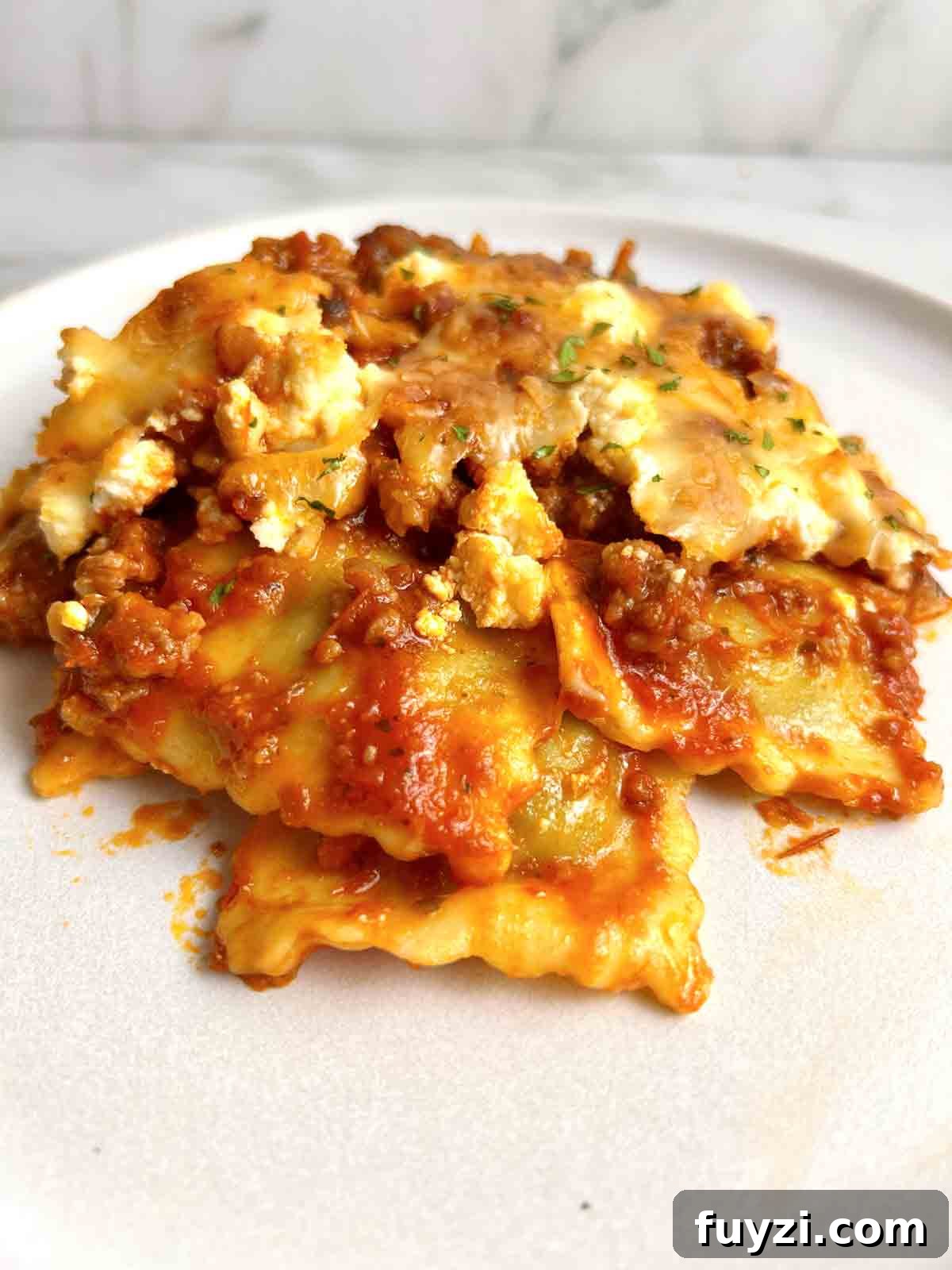 slice of ravioli lasagna on plate.