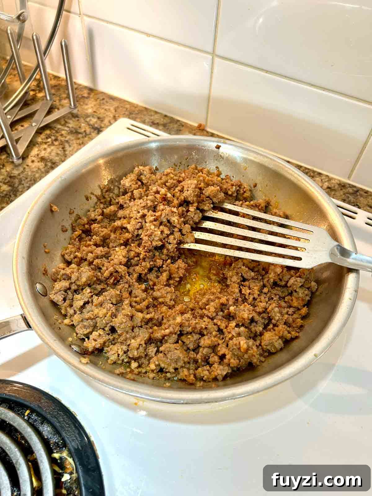 sausage cooking in skillet.