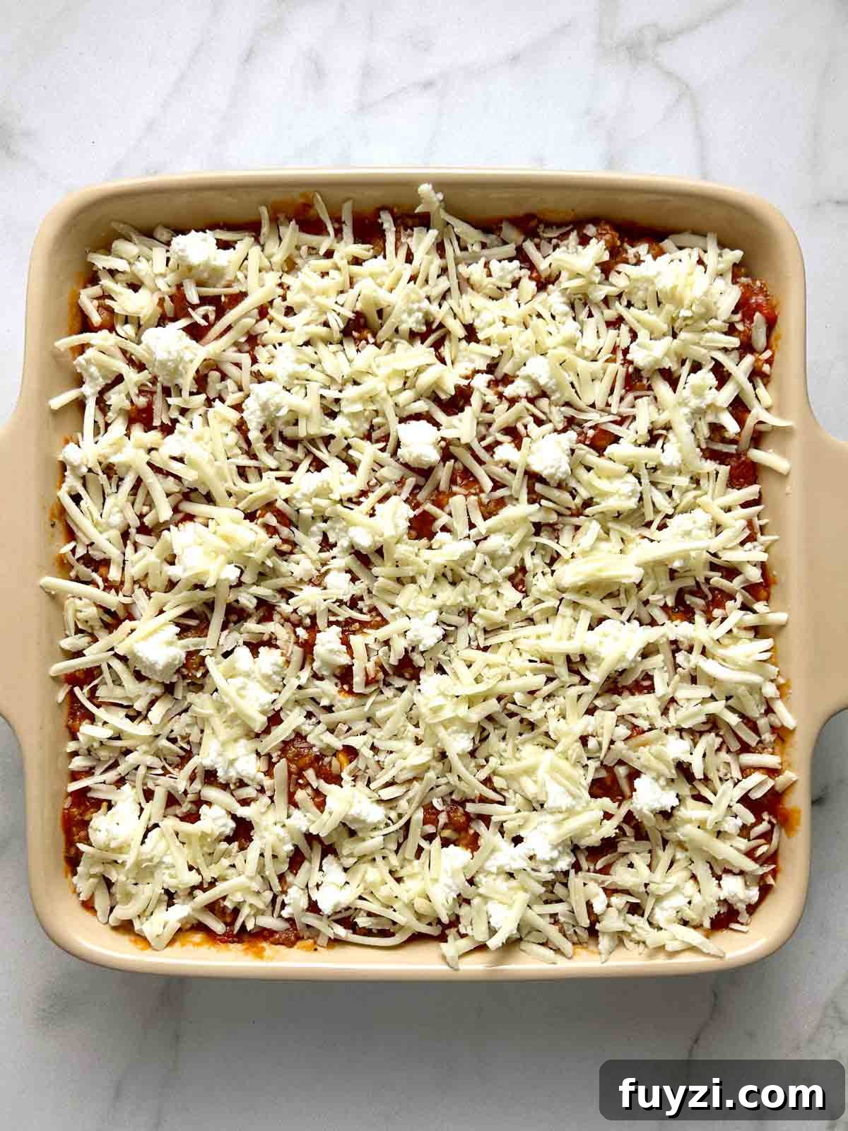 all layers of ravioli lasagna in casserole dish.
