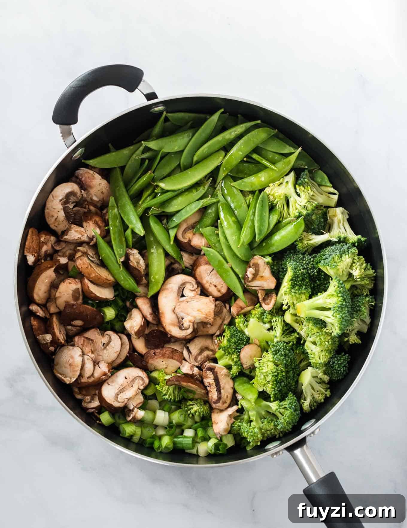 mushrooms, sugar snap peas, broccoli, and green onions in a large skillet