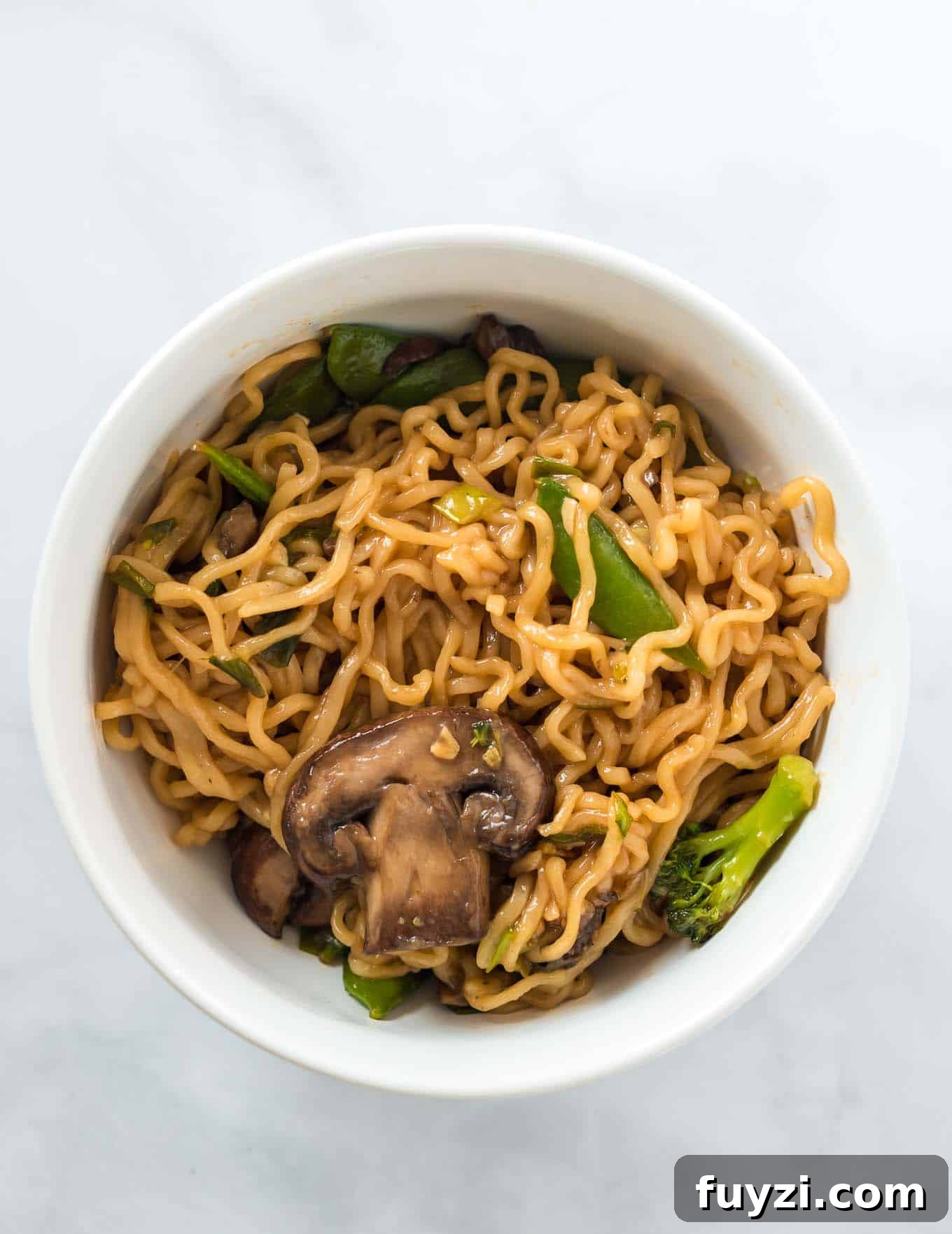 ramen noodles with vegetables in a white bowl